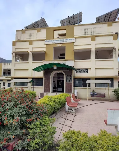Front view of Narasinha Mehta Dham with garden seating and rooftop solar panels